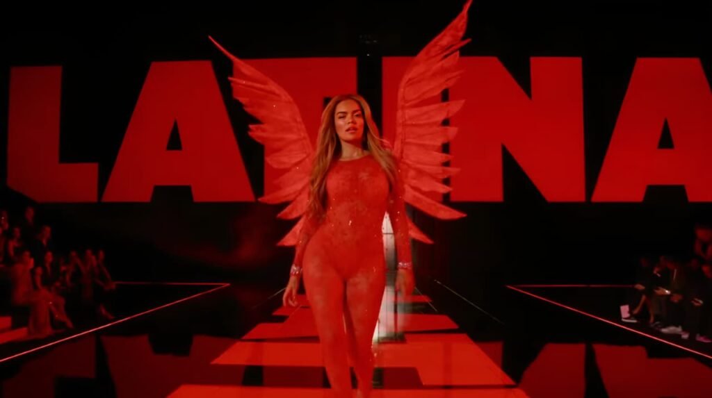 Karol G performing live at Victoria’s Secret Fashion Show 2025 wearing red angel wings.